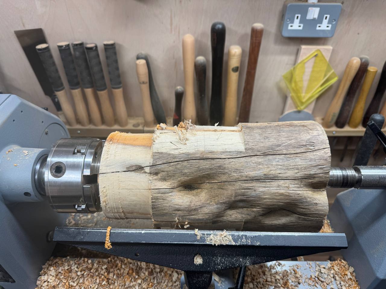 The raw yew branch mounted on the lathe