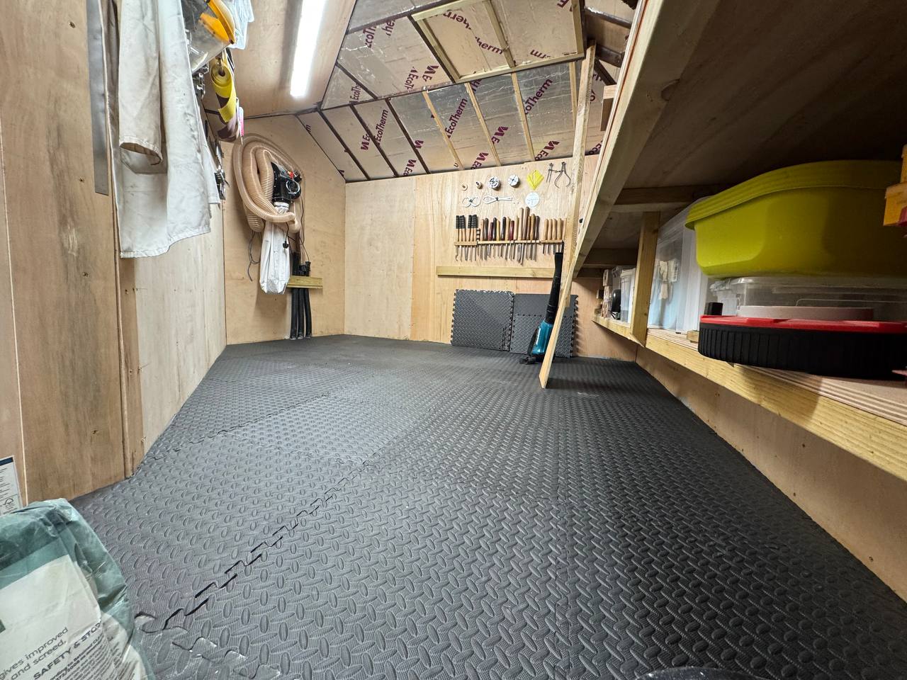 Workshop interior with plywood lining and interlocking floor
