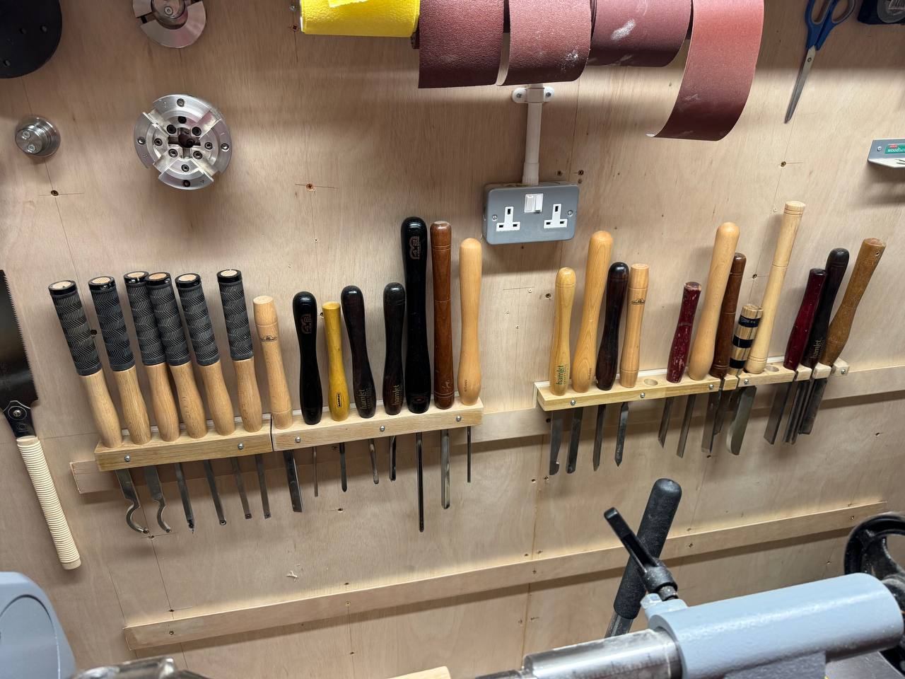 Gouges and chisels organised on custom wall rack